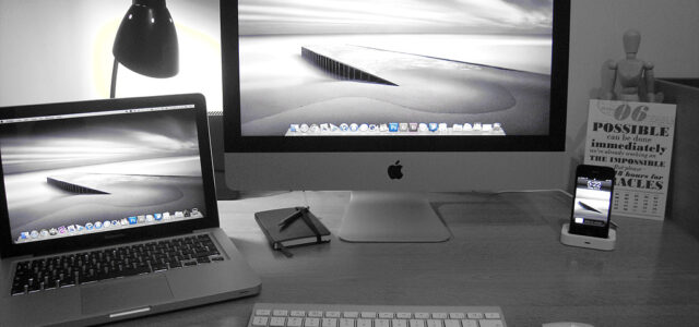 A photo of a home office full of Apple products.